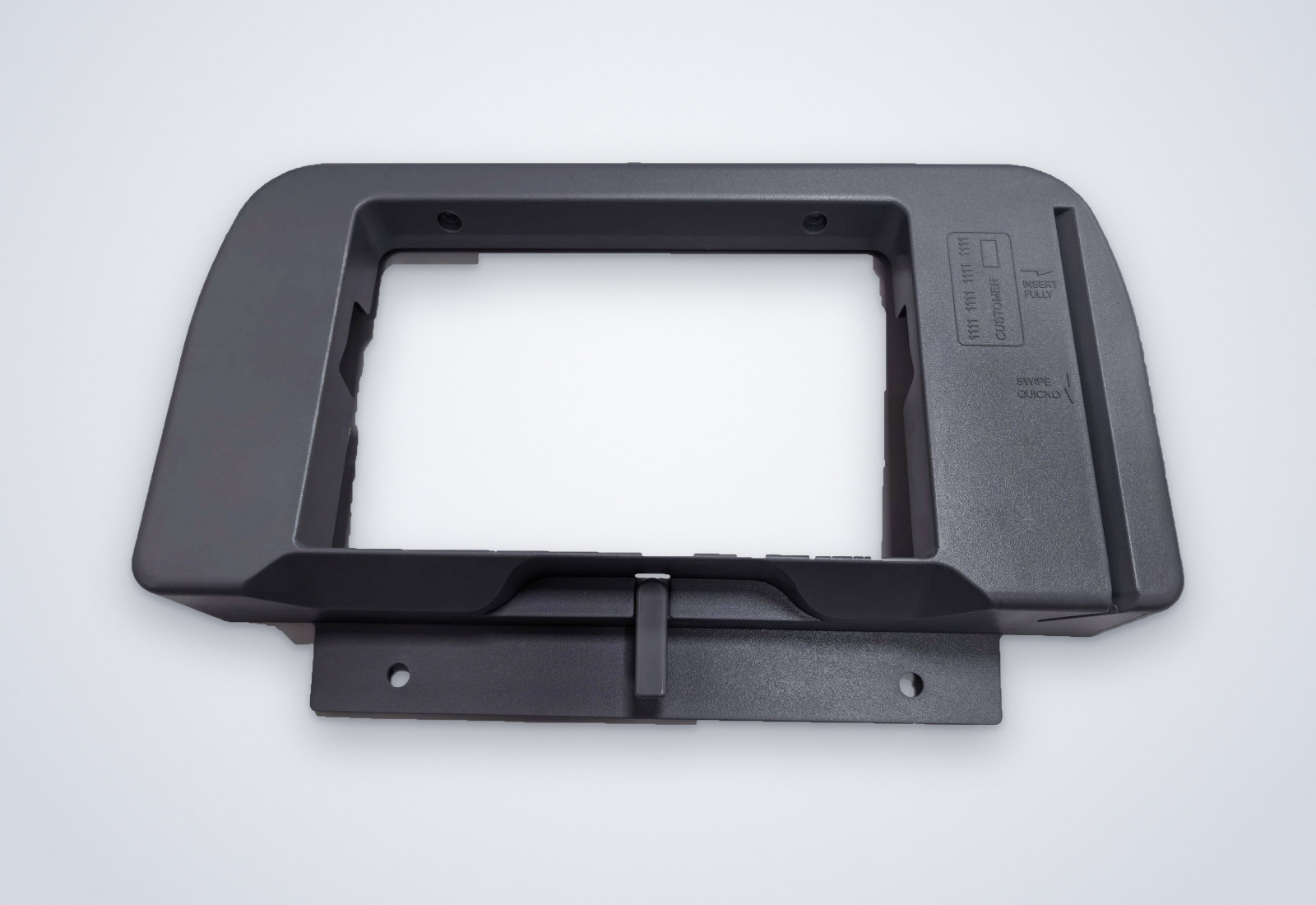 Grey molded seat-back monitor frame with a rectangular screen opening and mounting flange